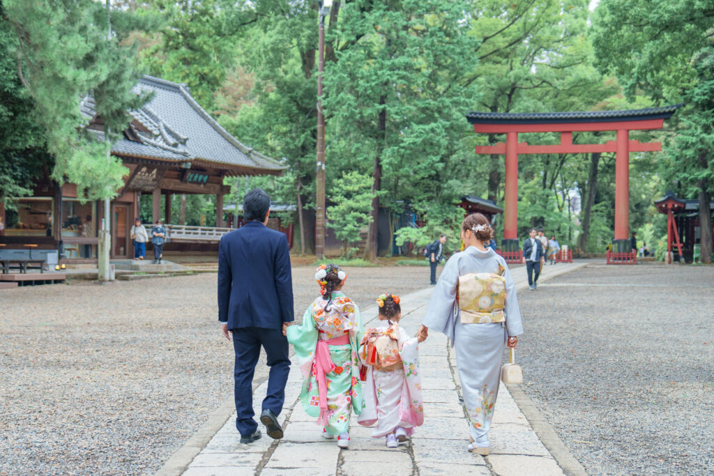 七五三のお祝いで神社の参道を歩くご家族